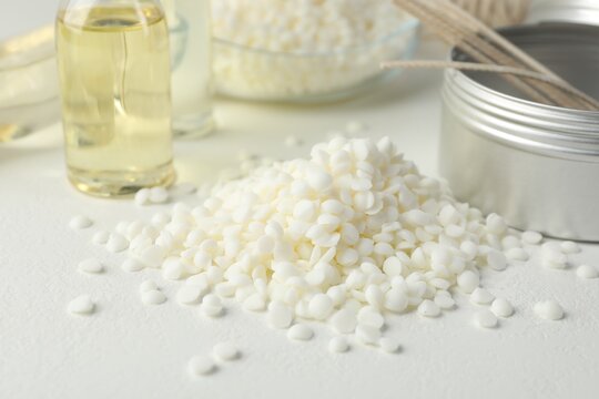 Soy wax and scented oil on white table, closeup. Candle making