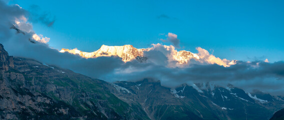 Europe, Switzerland. Panoramic of mountains and clouds at sunset.
