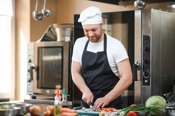 Chef cook preparing vegetables in his kitchen