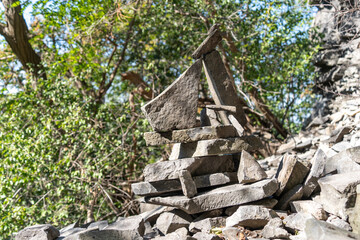 Fototapeta premium Stone towers piled up by traveling tourists in a natural environment