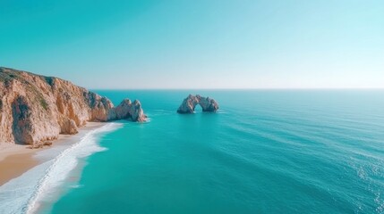 Obraz premium A stunning aerial view of the iconic Arch at Cabo San Lucas with pristine beaches and turquoise waters under a clear blue sky.