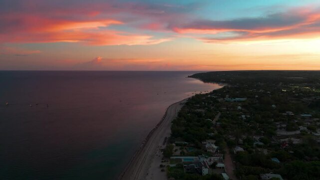 Aerial 4K footage of the early sunrise over the coast in Mahajanga City Area, North West Madagascar, showcasing the stunning sunrise colors and coastal scenery.