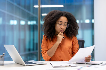 Thinking woman financier reading report, businesswoman holding document in hands. Office worker...