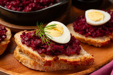Beet or beetroot Caviar sandwich with boiled quail egg, bread and roasted vegetable toast. Healthy snack.