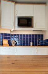 empty desk space and blurred kitchen background
