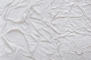 Fototapeta premium Crinkled white paper texture fills the entire background.