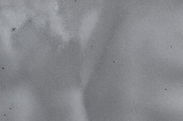 a gray concrete wall texture with minor imperfections.