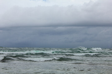 stormy waves crashing on the sea with a dark sky background