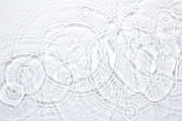 Rippled surface of clear water on white background, top view