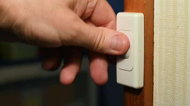 240 volt light switch man&rsquo;s hand repeatedly switching switch off and on and off Obsessive Compulsive Disorder OCD concept 
