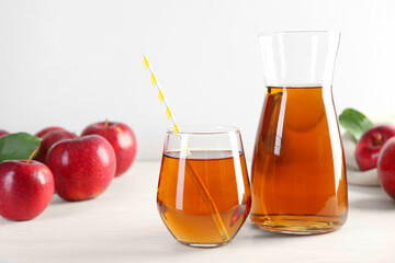 Fresh apple juice and fruits on white wooden table