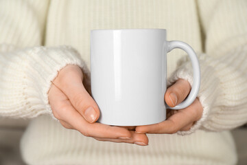 Woman with white ceramic cup, closeup. Mockup for design