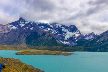 Torres del Paine national park in Patagonia, Chile. Beautiful landscape of Torres del Paine peaks, Los Cuernos and Paine Grande mountain summit in nasty weather with some dark clouds before the storm.