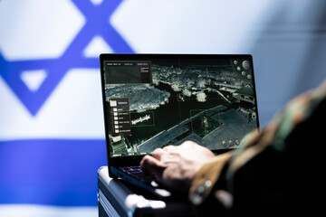 Officer in command center responsible for Israel air defense relaying instructions to squadrons patrolling over borders. Military intelligence agency spy using laptop software to do monitoring