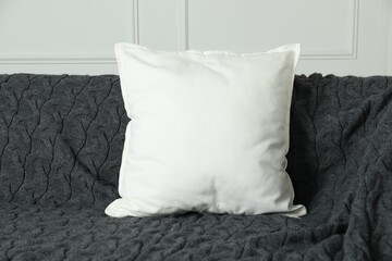 Blank soft pillow on cozy couch indoors