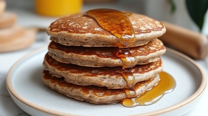 Honey-drizzled pancakes on plate, kitchen setting, breakfast
