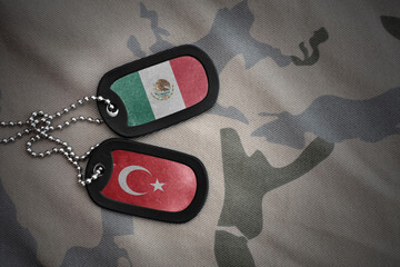 Obraz premium vintage army blank, dog tag with flag of mexico and turkey on the khaki texture background. military concept.