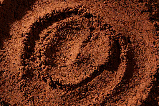 Natural dark brown cocoa powder textured background, closeup, top view