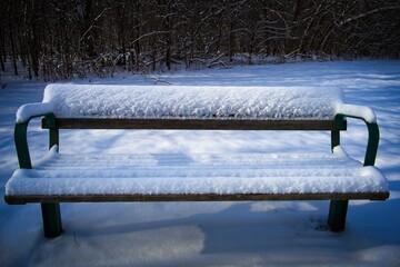 Snow-Covered Bench in Winter Landscape