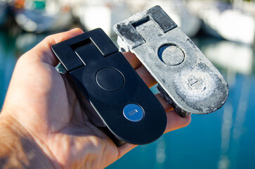 Two locks for the sailing yacht's lockers. One is old, and one is new as a replacement
