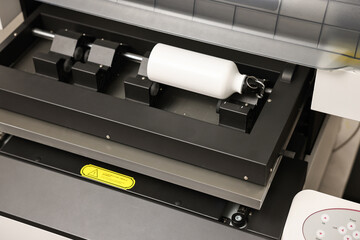 Modern printer and bottle with carabiner indoors, closeup