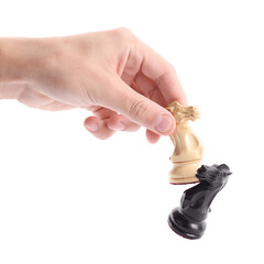 Man with white chess knight knocking over black one on white background, closeup. Competition concept © New Africa