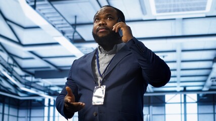 IT support worker in data center talking in phone call, doing yearly checkup. On field engineer...