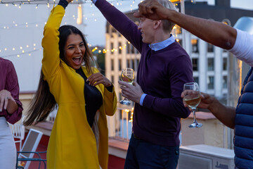Friends Celebrating a Vibrant Rooftop Party with Laughter and Lights
