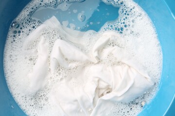 White clothes soaked in water before washing, top view