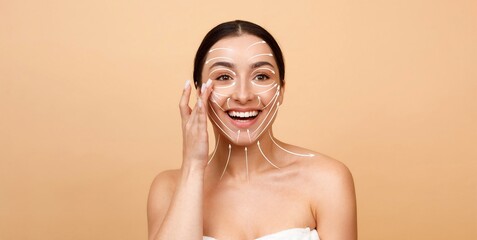 A woman with a radiant smile applies skincare products on her face, showcasing a glow. The setting...