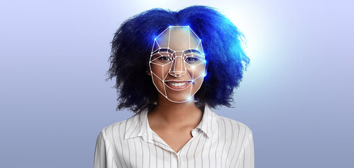 A woman with curly hair smiles as facial recognition technology scans her features. This...