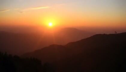 Obraz premium Majestic Sunset Over Silhouetted Mountains With Flag