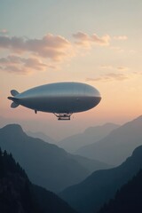 Fototapeta premium A massive silver airship floats gracefully over a misty mountain range at sunrise, with soft orange and pink hues in the sky and scattered clouds