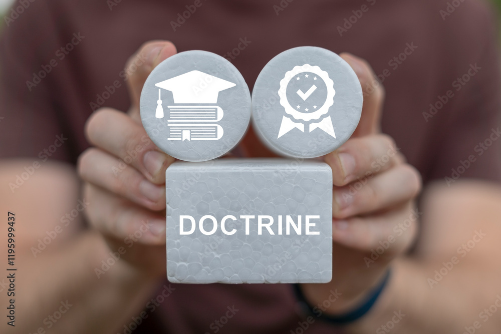 Fototapete person holding blocks sees word: doctrine. doctrine business concept. doctrine - body of teachings o