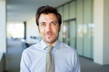 Confident businessman smiling in modern office building