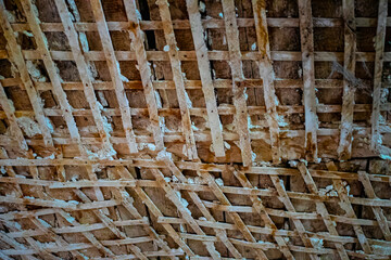 Rough surface of old retro wood ceiling slabs. The ruin of an abandoned house. Textured background....
