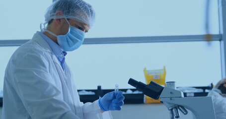 Image of data processing and world map over caucasian male scientist