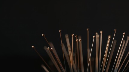 Abstract Close-up of Golden Thin Rods Against Black Background.