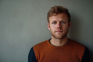 Obraz premium Portrait of a Confident Young Man with Natural Expression Against a Neutral Background