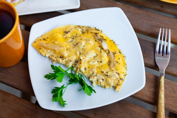 Thin omelette served with bread for breakfast closeup