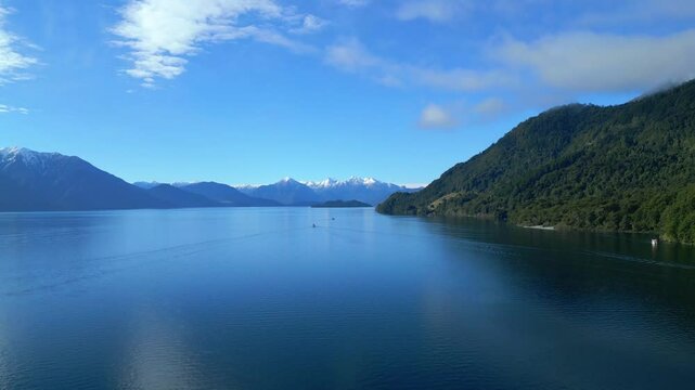 Aerial View of Pristine Lake Surrounded by Mountains and Forests
