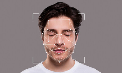A person with closed eyes is engaged in facial recognition technology. An overlay of geometric...