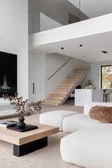 Modern minimalist living room with white furniture, a light wood coffee table, and a floating staircase leading to an upper level in a contemporary home.