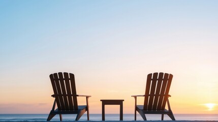 Serene Beach Sunrise with Wooden Chairs and Table Silhouetted Against a Colorful Sky