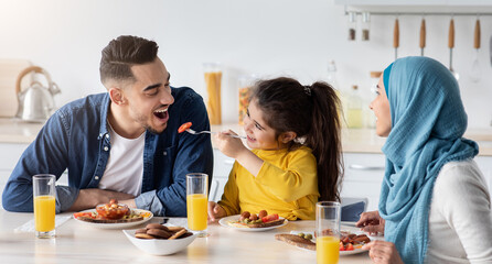 Breakfast Time. Happy Muslim Family Of Three Having Morning Meal Together In Kitchen, Cheerful...