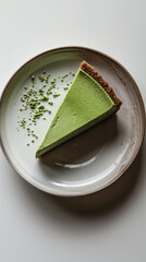 Delicious slice of matcha cheesecake on a minimalist plate with intricate details and open space for creativity