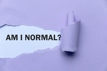 Purple Torn Paper Revealing the Word 'Am i normal?'. 