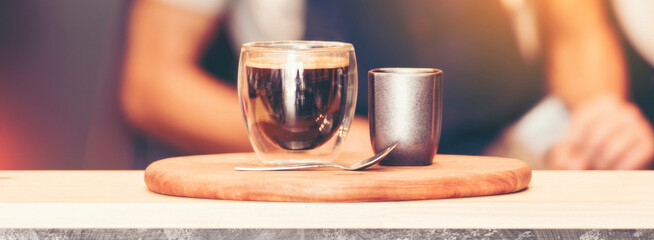 Banner coffee cup shot on wood table with copy space at retro coffee shop. Vintage hot black coffee fresh drinking espresso caffeine shot in morning.