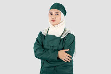 portrait of a female doctor wearing green surgical folded her arms over her chest