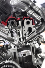 Shiny new automotive engine with cut section showing inside details.